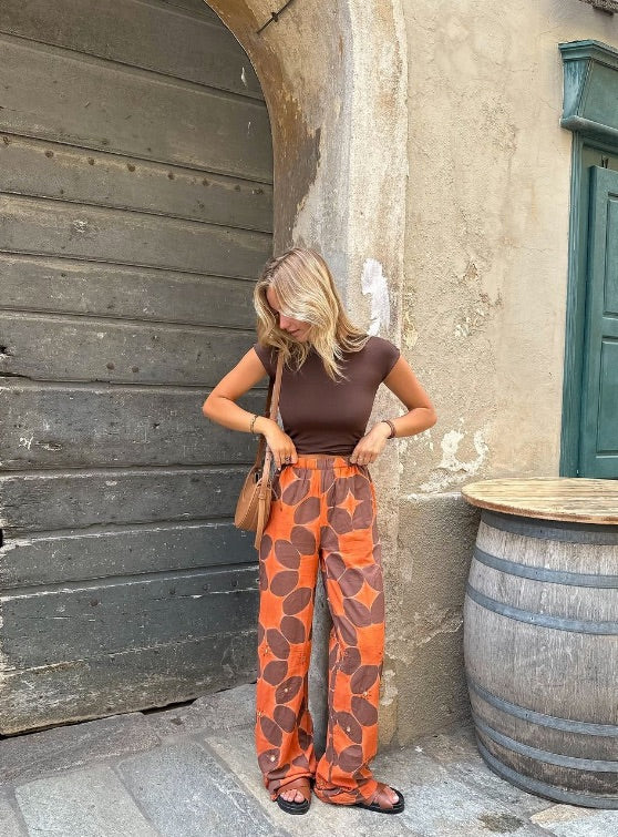 Cramp embroidered orange tie-dye pants